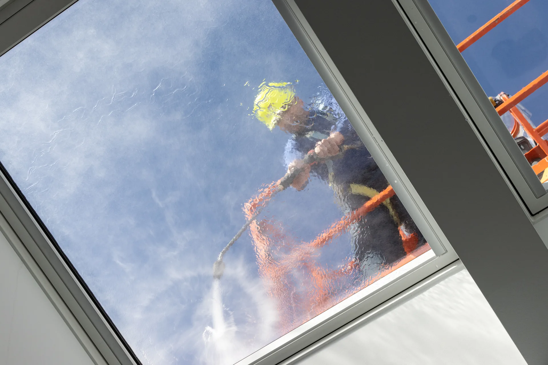 Window cleaner washing the exterior glass of a commercial building